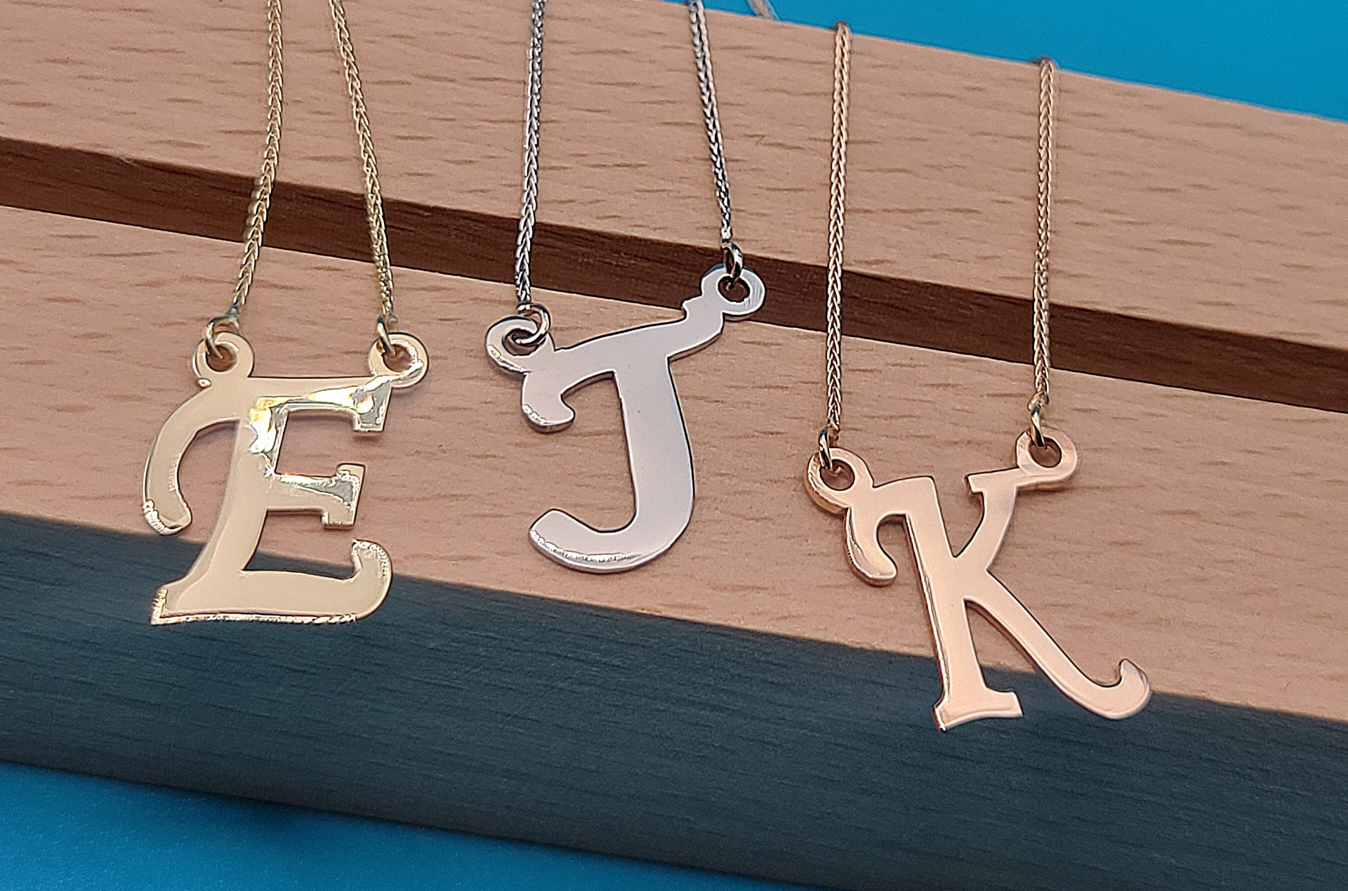 Slide 5of5: 3 lovely initial necklaces: 'E' in yellow gold, 'J' in white gold and 'K' in rose gold